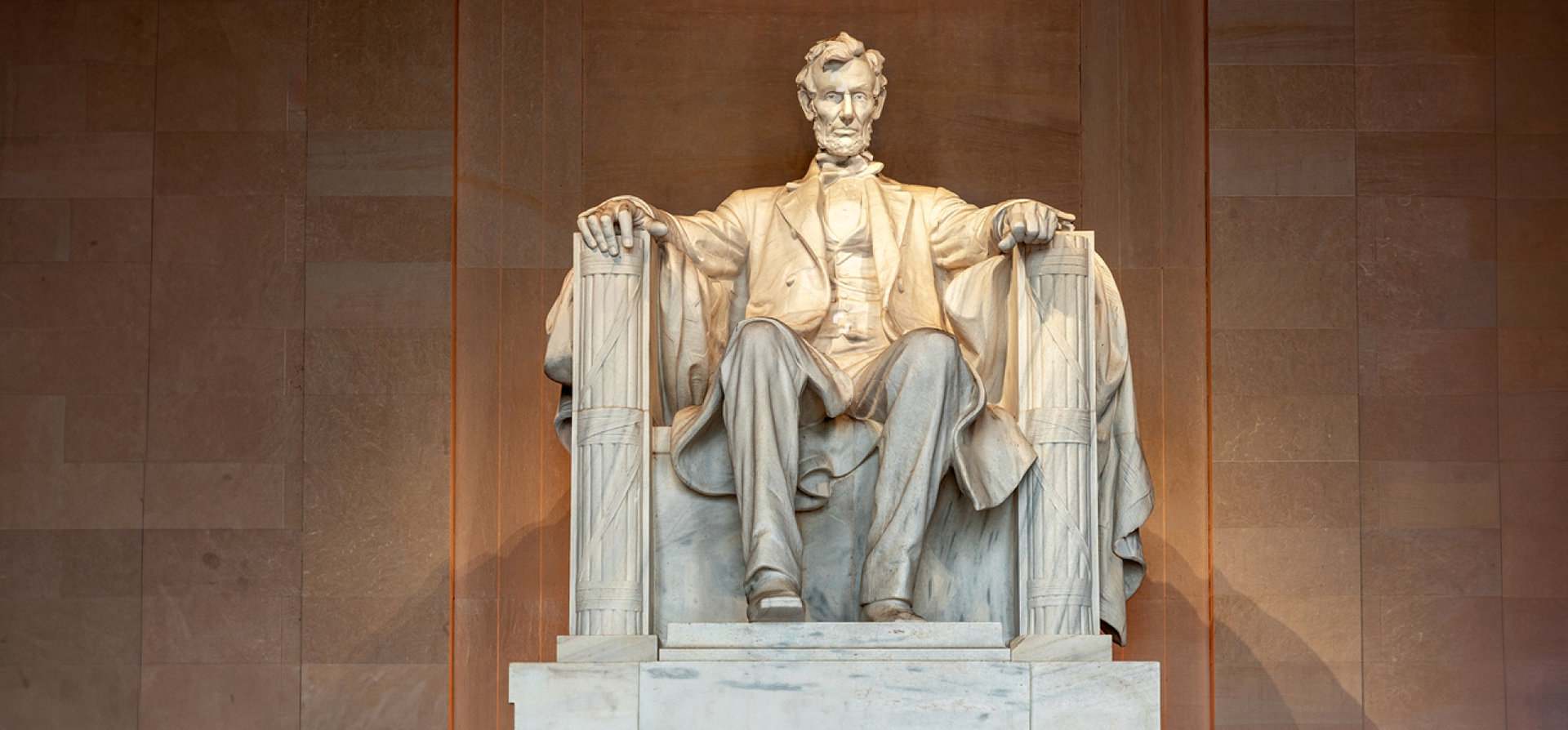 a stone sculpture of a man sitting down