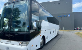 White bus parked in front of a building