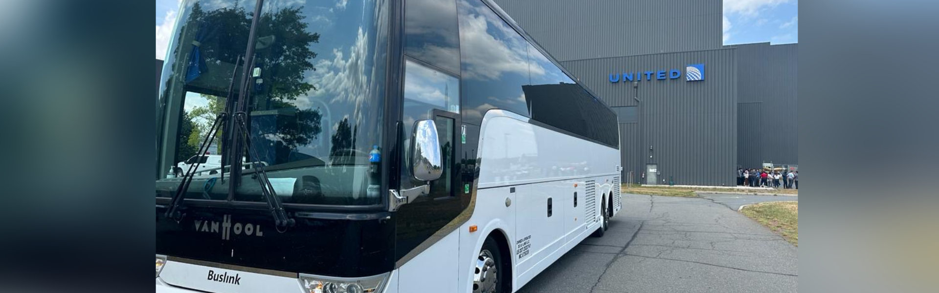 White bus parked in front of a building